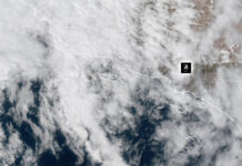 Weather: Hot, Humid, Rainy, What the heck – Heat Warning In Effect NOAA Weather Satellite image showing cloud cover over a coastal region and adjacent ocean, with dashed border lines and a small black location marker.