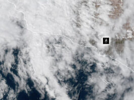 Weather: Hot, Humid, Rainy, What the heck – Heat Warning In Effect NOAA Weather Satellite image showing cloud cover over a coastal region and adjacent ocean, with dashed border lines and a small black location marker.
