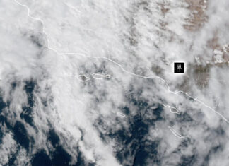 Weather: Hot, Humid, Rainy, What the heck – Heat Warning In Effect NOAA Weather Satellite image showing cloud cover over a coastal region and adjacent ocean, with dashed border lines and a small black location marker.