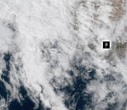 Weather: Hot, Humid, Rainy, What the heck – Heat Warning In Effect NOAA Weather Satellite image showing cloud cover over a coastal region and adjacent ocean, with dashed border lines and a small black location marker.