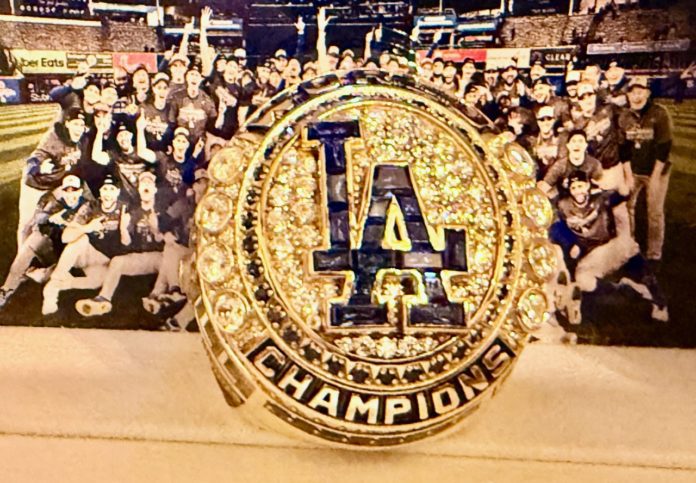 PHOTO Credit: Los Angeles Dodgers | Expertly crafted in 14-karat yellow gold, diamonds and genuine sapphires, team historian Mark Langill says the Los Angeles Dodgers’ 2024 World Series Ring honors the team’s historic season and 8th title in franchise history through artistic storytelling and impeccable detail.