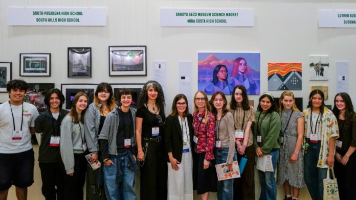 PHOTP: SPHS | The South Pasadenan | SPHS students, Photography Teacher Rouzanna Berberian (center left), SPUSD Superintendent Angela Elizondo Baxter (center), and Art Teacher Aimee Levie-Hultman (center right) during the Autry Student Visual Arts Exhibition opening reception.