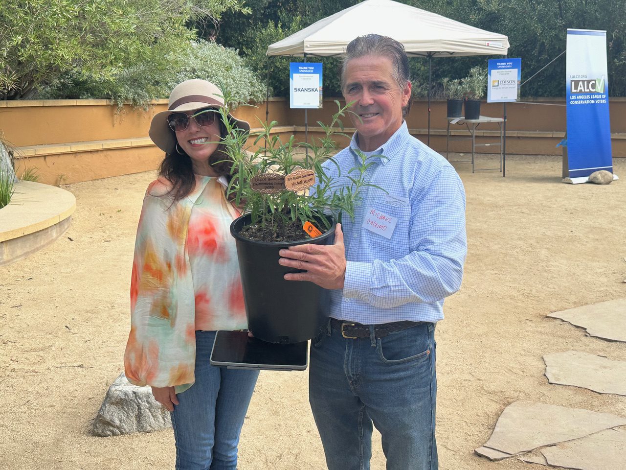 | The South Pasadenan | South Pasadena News PHOTO: Bill Glazier | The South Pasadenan | Maricella Gomez, a board member with the Los Angeles League of Conservation Voters, presented South Pasadena City Councilman Michael Cacciotti with a Sweet Sage plant after earning a Smith-Weiss Environmental Champion Award at an event at the Audubon Center in Los Angeles’ Debs Regional Park Sunday. Cacciotti earned a Smith-Weiss Environmental Champion Award from the Los Angeles League of Conservation Voters.