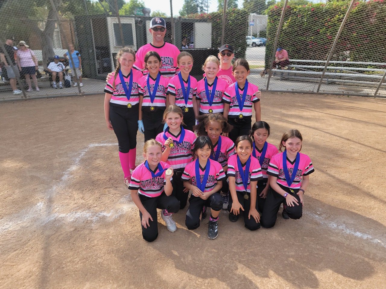 | The South Pasadenan | South Pasadena News PHOTO: Little League Baseball | The South Pasadenan | The Pink Nightmares minors softball team gathers for a team photo on the field in their pink and black uniforms.