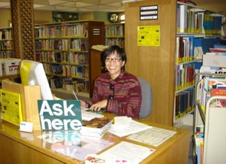 Photo Courtesy of South Pasadena Public Library | The South Pasadenan | Public Services Manager Maida Wong sits behind the reference desk at South Pasadena Library. Wong is retiring after working at the library over the past 37 years.