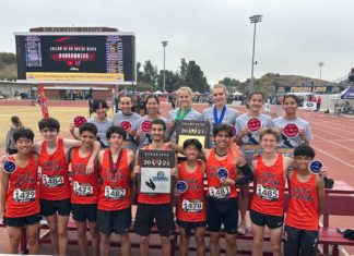 PHOTO: SPUSD | Tigers coach Mike Parkinson holds plaques awarded to the SPHS boys’ and girls’ cross country teams following the CIF Finals on Saturday in Walnut. South Pasadena High excelled mightily in three sports last Saturday, bringing home a collection of CIF-Southern Section plaques in three sport competitions – cross country, volleyball and water polo.