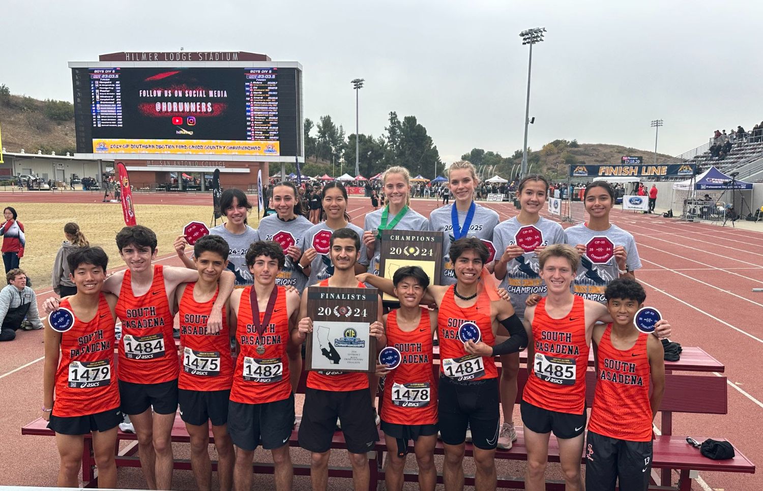 | The South Pasadenan | South Pasadena News PHOTO: SPUSD | Tigers coach Mike Parkinson holds plaques awarded to the SPHS boys’ and girls’ cross country teams following the CIF Finals on Saturday in Walnut. South Pasadena High excelled mightily in three sports last Saturday, bringing home a collection of CIF-Southern Section plaques in three sport competitions – cross country, volleyball and water polo.