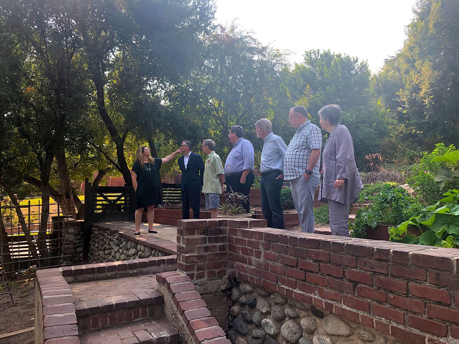 | The South Pasadenan | South Pasadena News PHOTO: South Pasadena News | Lori Davis-Denny, on the backyard Greene & Greene steps, describes features of the Garfield House to members of the South Pasadena Preservation Foundation (SPPF).