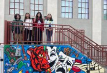 Colorful Student-Created Banner Livens Exterior of SPMS Arts Building PHOTO: Denise Tanaka | The South Pasadenan | SPMS students gather around a newly completed banner on the middle school Arts Building.