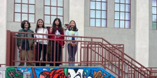 PHOTO: Denise Tanaka | The South Pasadenan | SPMS students gather around a newly completed banner on the middle school Arts Building.