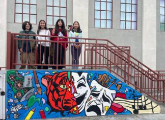 PHOTO: Denise Tanaka | The South Pasadenan | SPMS students gather around a newly completed banner on the middle school Arts Building.