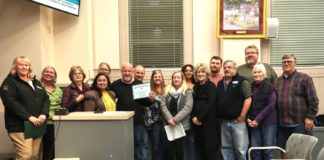PHOTO: Samantha Shiroishi | The South Pasadenan | South Pasadena Tournament of Roses Committee and volunteers gather for a photo inside the South Pasadena City Council Chambers following the high recognition from the city.