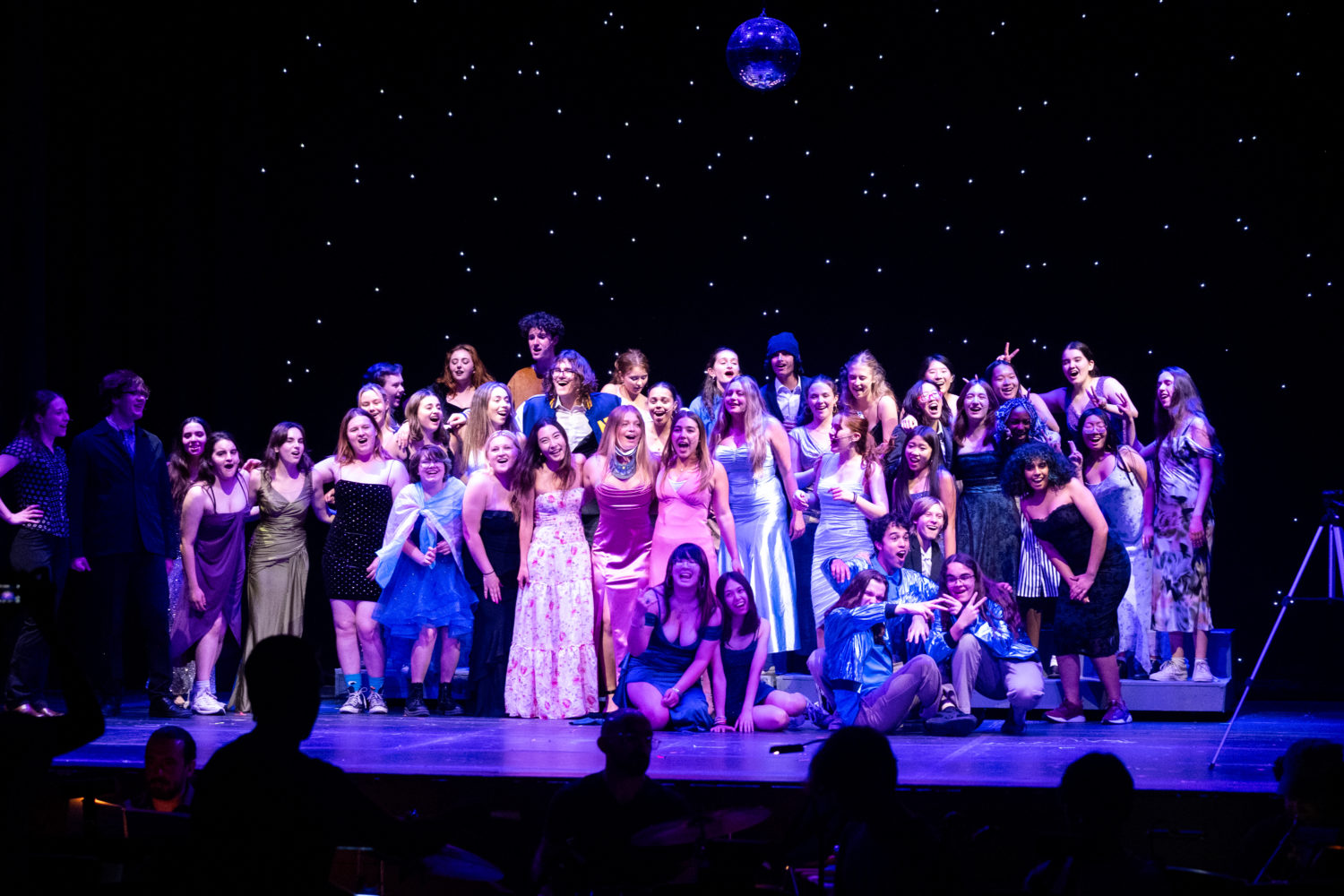 | The South Pasadenan | South Pasadena News Large group of teens in colorful dresses posing on a stage finale photo with a starry backdrop and a disco ball above them.