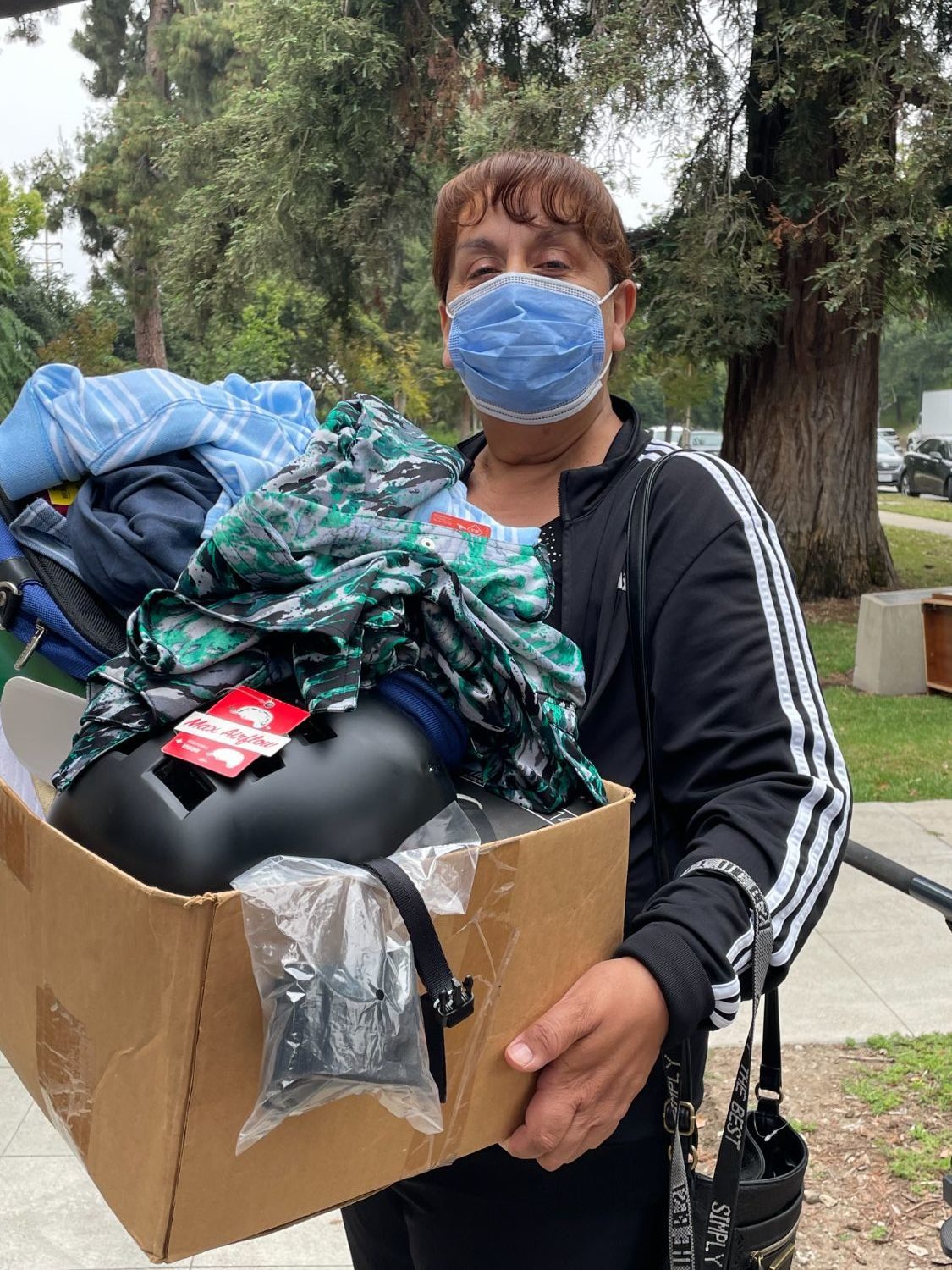 | The South Pasadenan | South Pasadena News PHOTO: Sally Kilby | The South Pasadenan | Sylvia Magallanes leaves War Memorial Building on the first day of the May South Pasadena Tournament of Roses yard sale with a box filled with useful items. She also bought a bicycle that day and then returned on the second day to shop further.