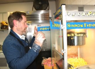PHOTO: Henk Friezer | The South Pasadenan | Mayor Jon Primuth serving up hot popcorn at the SPHS football game Friday evening.