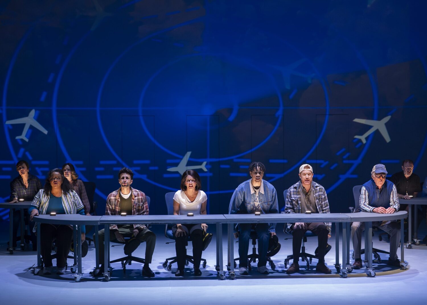 | The South Pasadenan | South Pasadena News Eight panelists sit along a long curved desk on a stage, with a blue aviation/ radar backdrop.