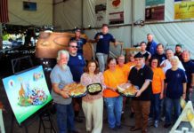 PHOTO: Henk Friezer | The South Pasadenan | Twohey’s Restaurant brings lunch to the South Pasadena Tournament of Roses’ Float work crew on Saturday, Oct. 21 at the float site at the War Memorial Building. Owners Tanya Christos (front, second from left) and Greg Mallis (front, wearing black shirt and holding platter) are providing complementary lunches for the crew during the float building and decoration season.