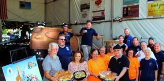 PHOTO: Henk Friezer | The South Pasadenan | Twohey’s Restaurant brings lunch to the South Pasadena Tournament of Roses’ Float work crew on Saturday, Oct. 21 at the float site at the War Memorial Building. Owners Tanya Christos (front, second from left) and Greg Mallis (front, wearing black shirt and holding platter) are providing complementary lunches for the crew during the float building and decoration season.