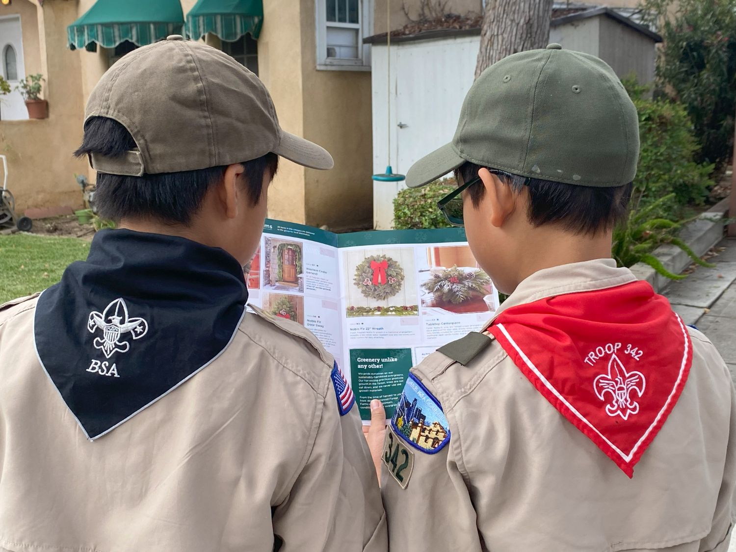 PHOTO: provided by Troop 342 | The South Pasadenan | Benji Beteta of Troop 7 in black neckerchief and Philip Kwak of Troop 342 in red neckerchief looking at a product flyer.