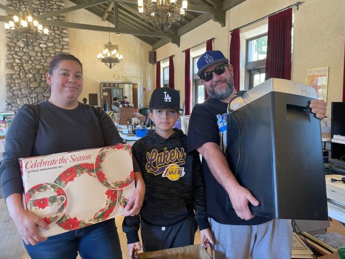 PHOTO: provided by SPTOR | South Pasadenan News | The Moreno Family finds dinnerware for the holidays and a shredder at the SPTOR sale.