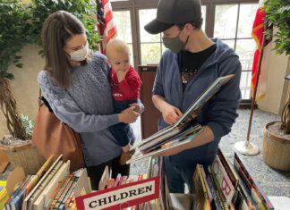 South Pasadena Public Library | Holiday Book Sale & Gift Marketplace PHOTO: Nancy Lem | South Pasadenan.com News | Ben and Michelle Corser shop for books for their son at the Holiday Book Sale.