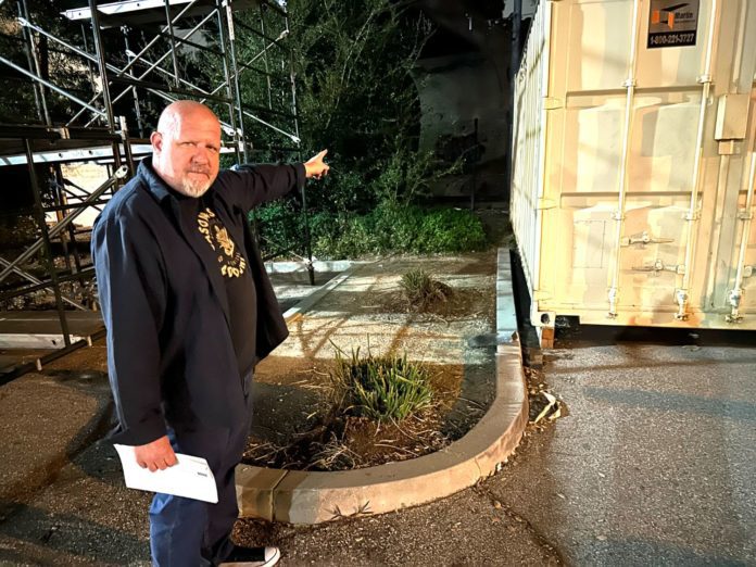 PHOTO: Bill Glazier | The South Pasadenan | Ed  Donnelly, chair of the South Pasadena Tournament of Roses, points to an area behind the War Memorial Building where a permanent building is projected to someday house the city’s float. Over the years, the float has been constructed in a giant circus-like tent at the site.