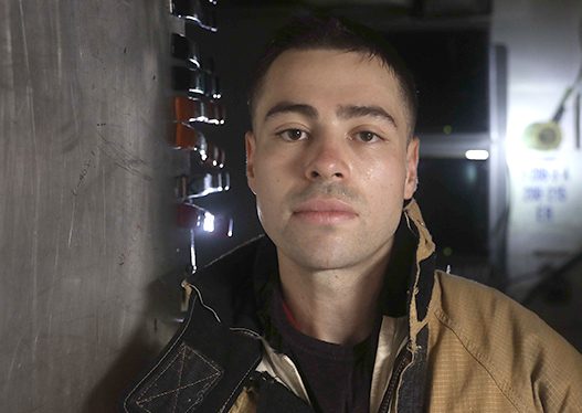 Jeremiah Escandon, from South Pasadena, California, poses for a photo in a repair locker aboard the Arleigh Burke-class guided-missile destroyer USS Milius (DDG 69)